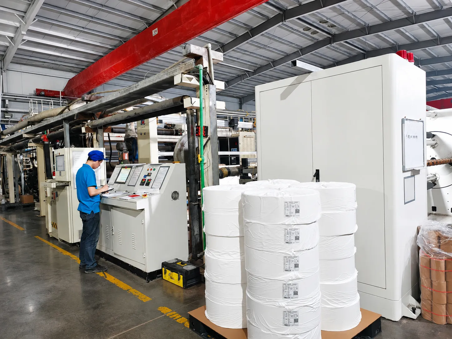 High-capacity nonwoven fabric production and automated slitting line for hygiene raw materials