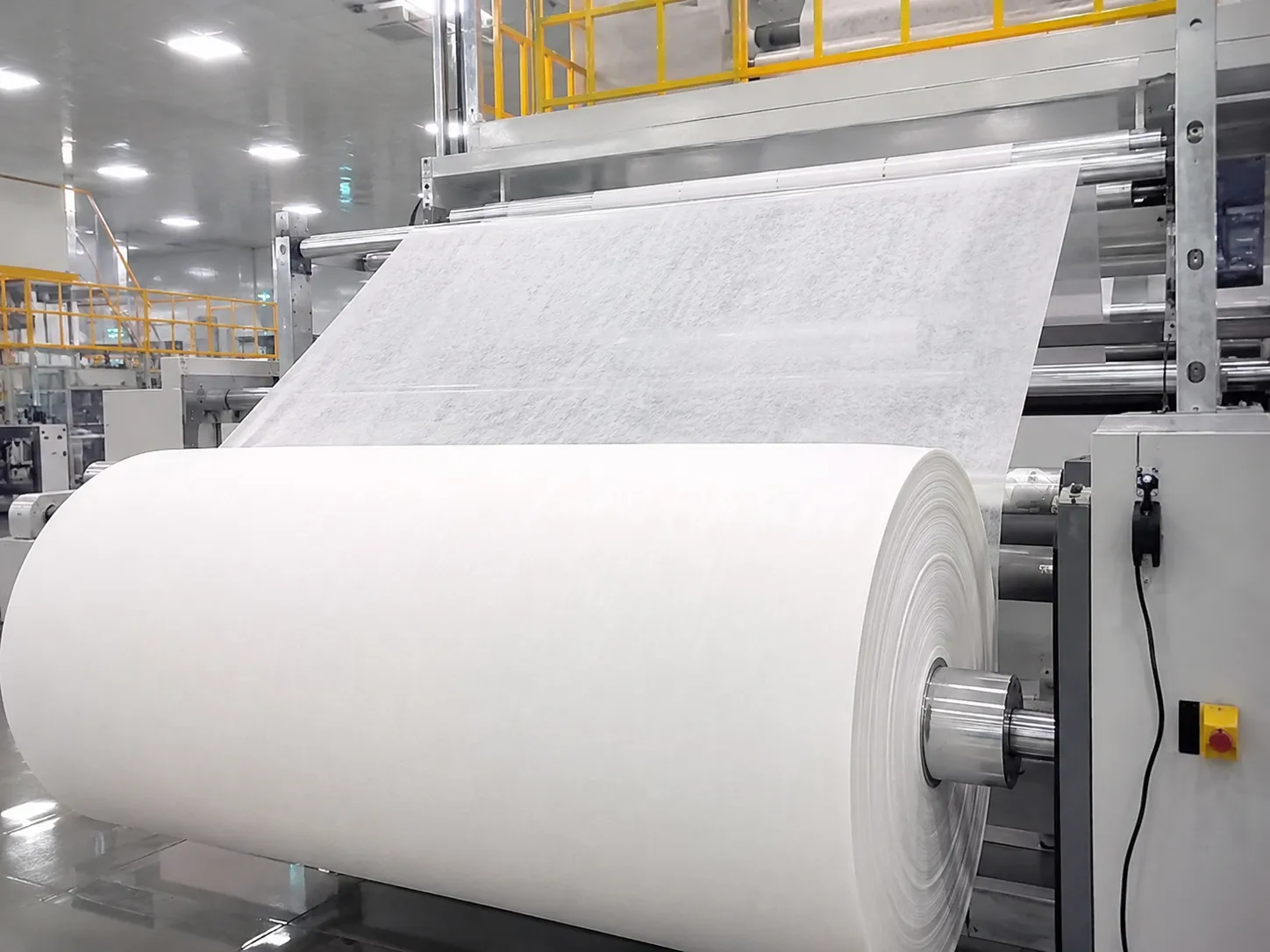 Jumbo nonwoven fabric roll on automated production line for hygiene product manufacturing