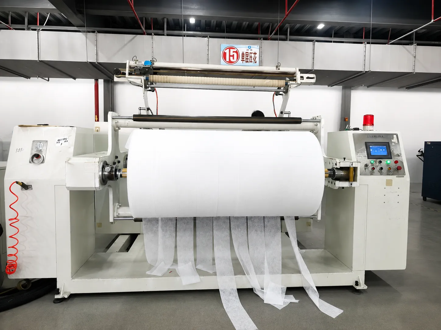 Precision nonwoven fabric slitting and embossing line for hygiene raw material manufacturing